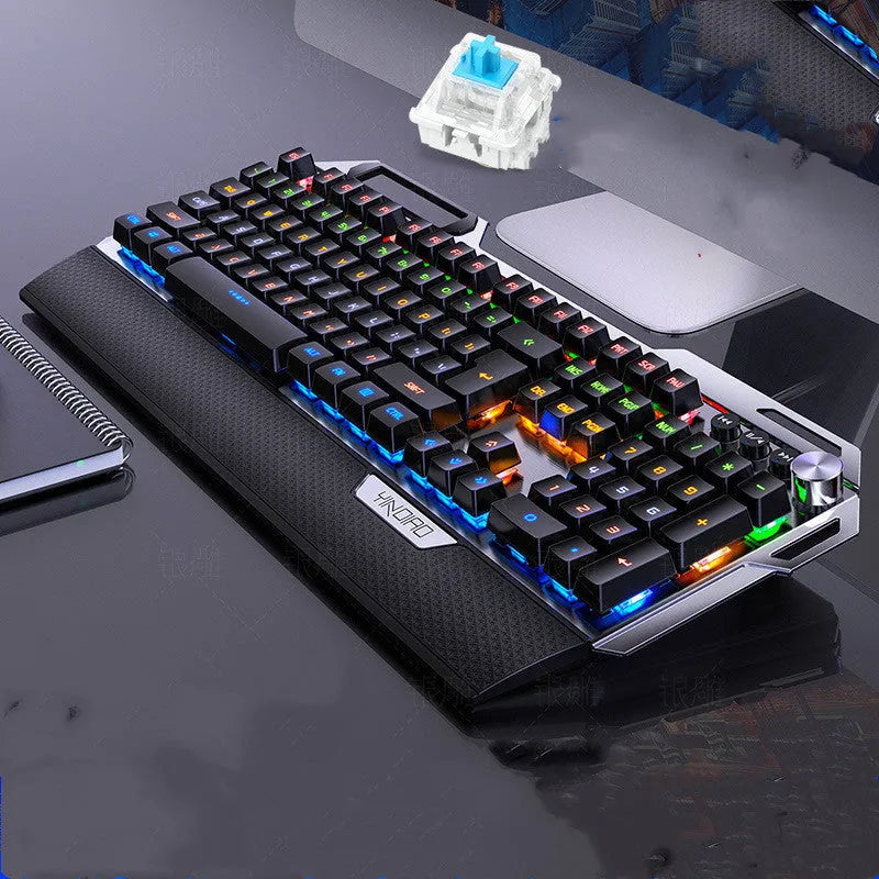 Silver Carving K100 metal mechanical keyboard with black axis keys, seven-color backlight, large hand rest, and phone holder on a desk