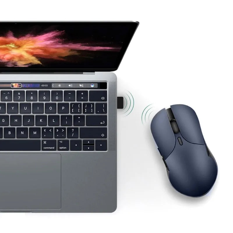 Blue Smart Voice Mouse with translation function on a desk next to a laptop.