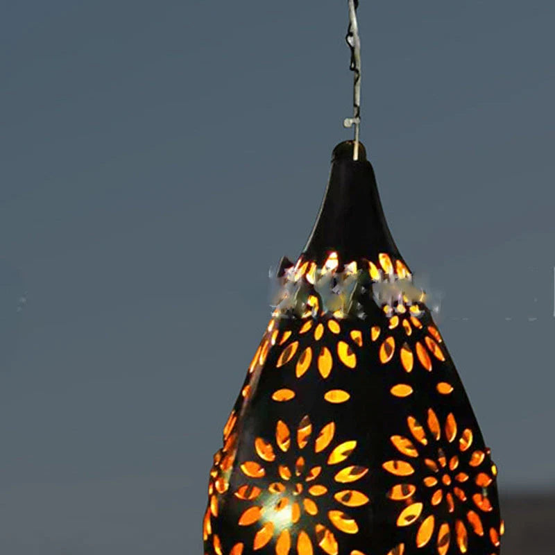 Solar-powered outdoor hanging lantern with flower-shaped light patterns and waterproof design for garden and patio decor