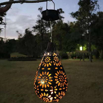 Solar-powered outdoor hanging lantern with flower-shaped light patterns and waterproof design for garden and patio decor