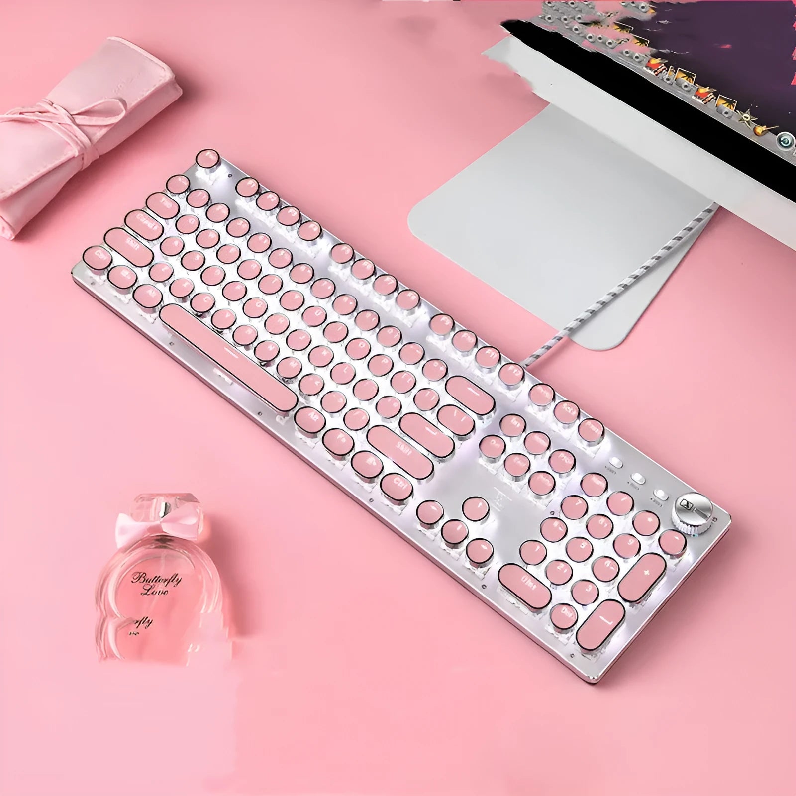 Silver and pink wired mechanical keyboard with green switches and matching ergonomic mouse.