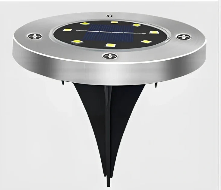 8LED waterproof solar garden light staked in lawn with warm glow, IP65 rated for rain resistance