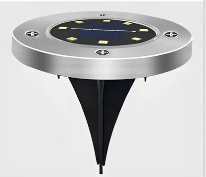 8LED waterproof solar garden light staked in lawn with warm glow, IP65 rated for rain resistance