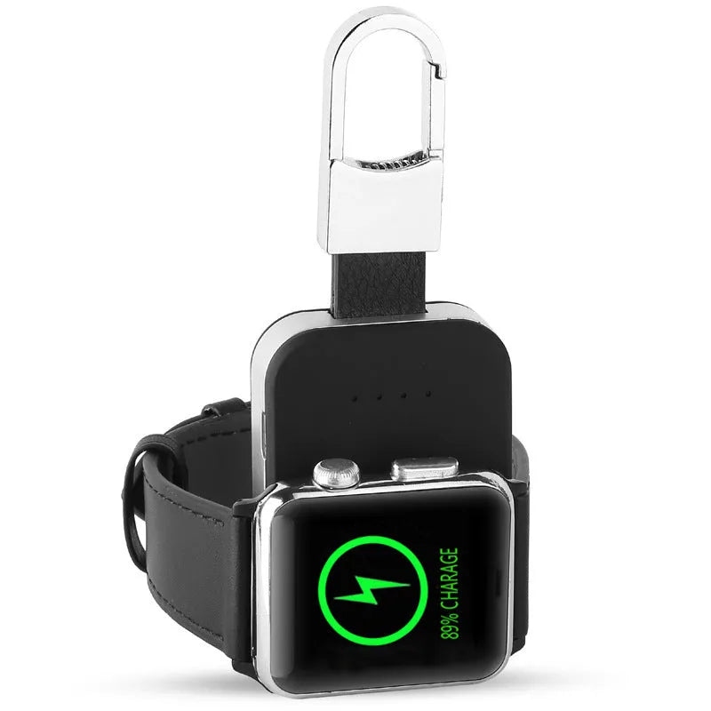 Black portable wireless power bank keychain for charging Apple Watch on a keyring.