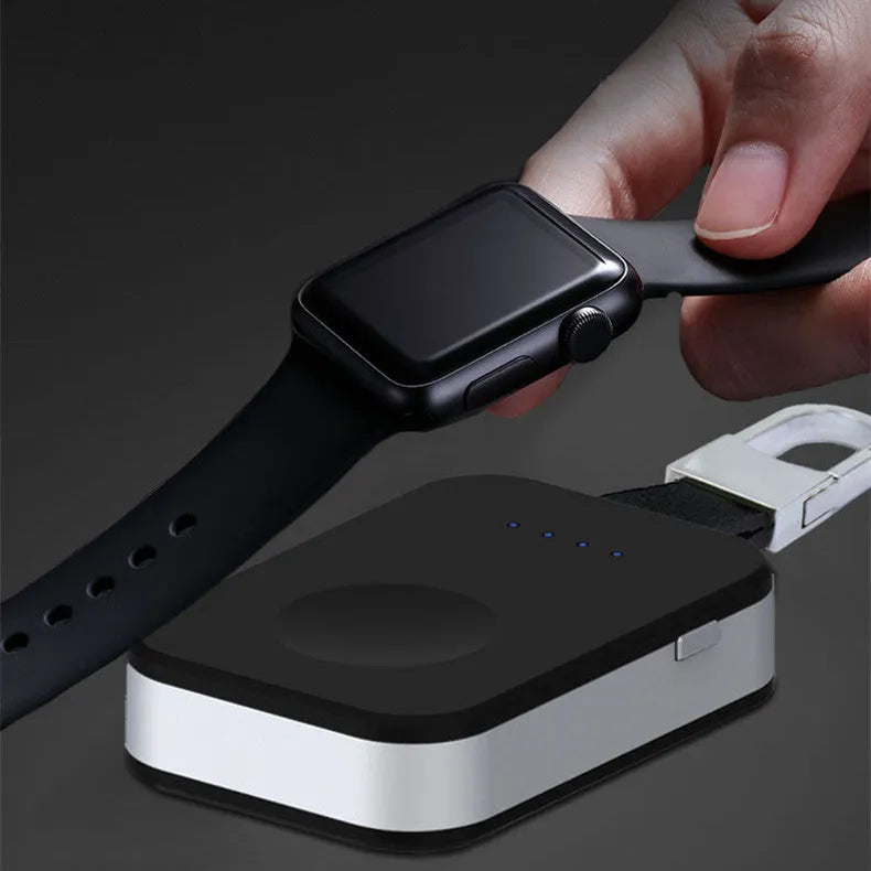 Black portable wireless power bank keychain for charging Apple Watch on a keyring.