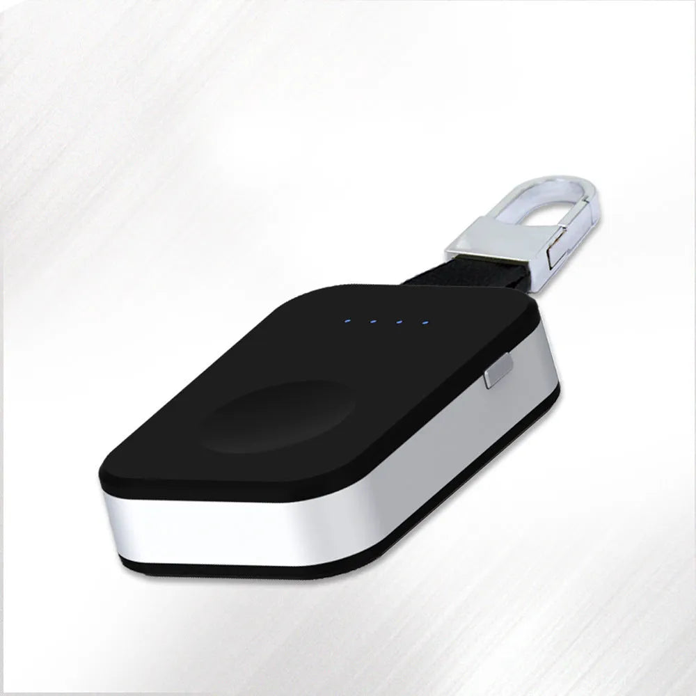 Black portable wireless power bank keychain for charging Apple Watch on a keyring.