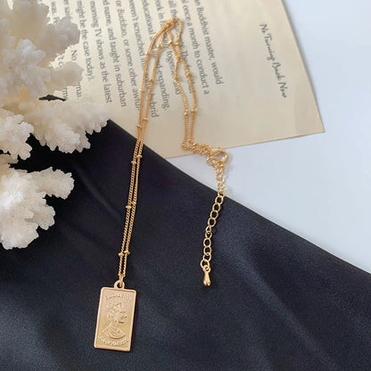 Gold alloy abstract face choker necklace with geometric pendant, adjustable snake bone chain