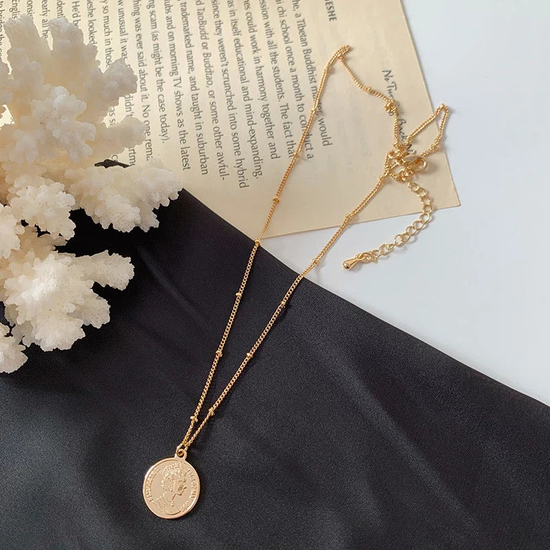 Gold alloy abstract face choker necklace with geometric pendant, adjustable snake bone chain