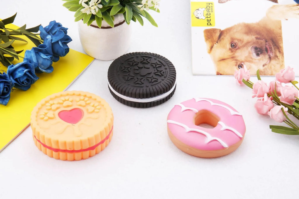 Creative dog molar ball toys in Oreo, pink donut, and love round biscuit shapes made from PVC vinyl