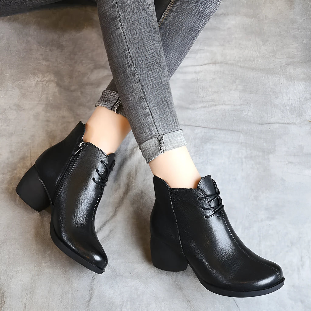 Brown leather women's Martin boots with a thick heel and round toe on a white background.