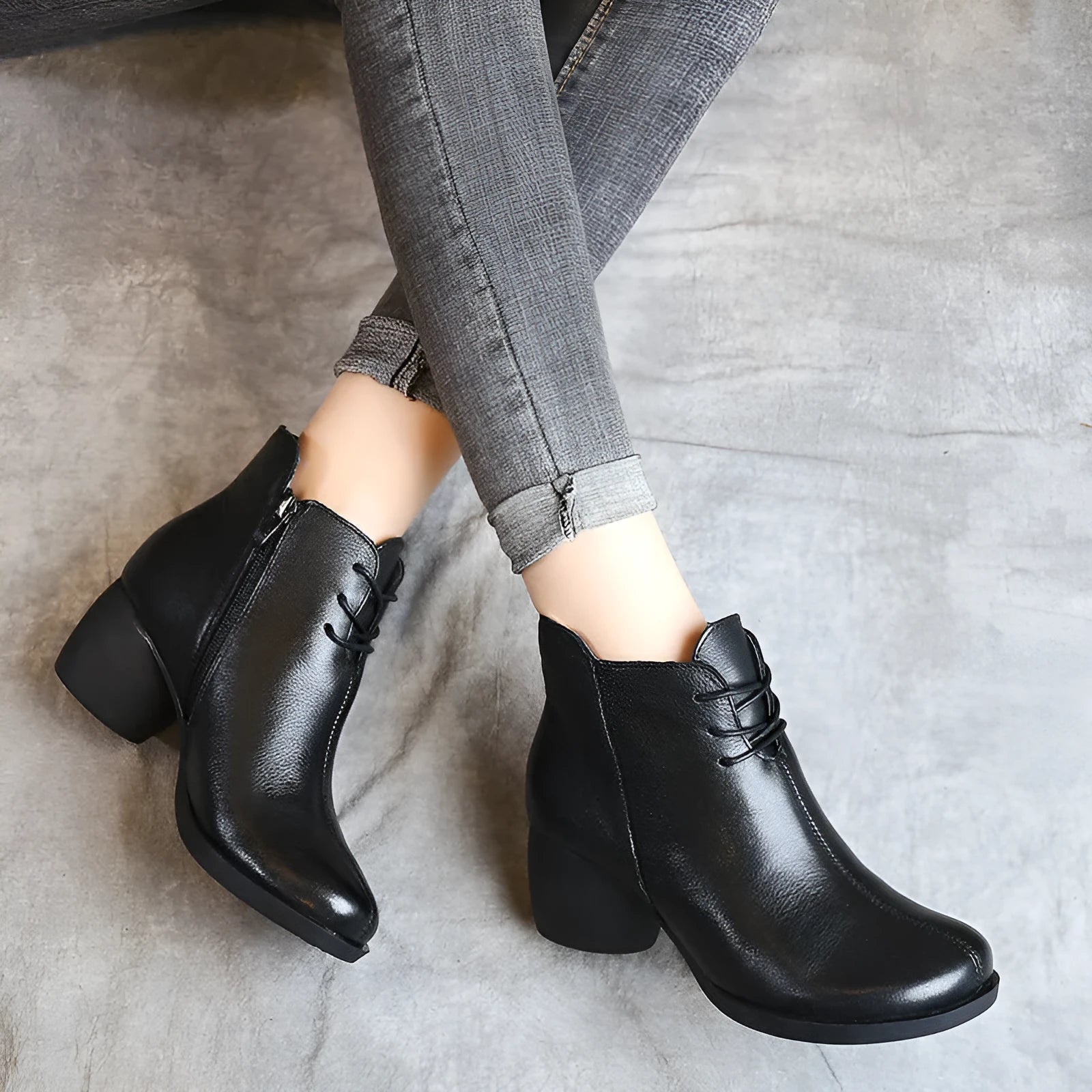 Brown leather women's Martin boots with a thick heel and round toe on a white background.