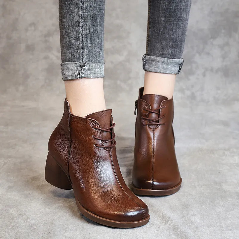 Brown leather women's Martin boots with a thick heel and round toe on a white background.