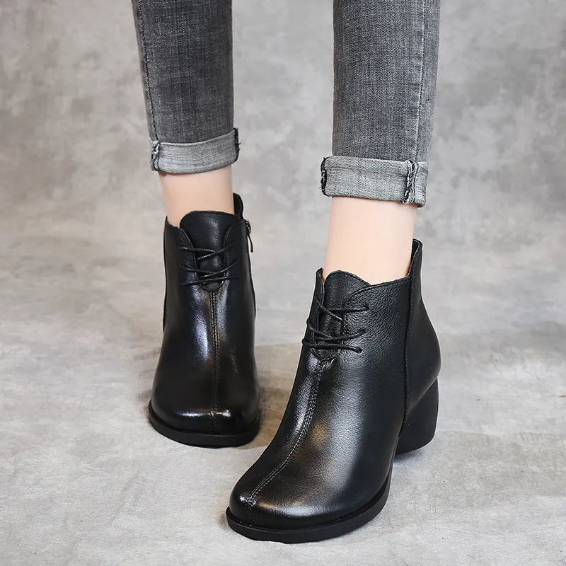 Brown leather women's Martin boots with a thick heel and round toe on a white background.