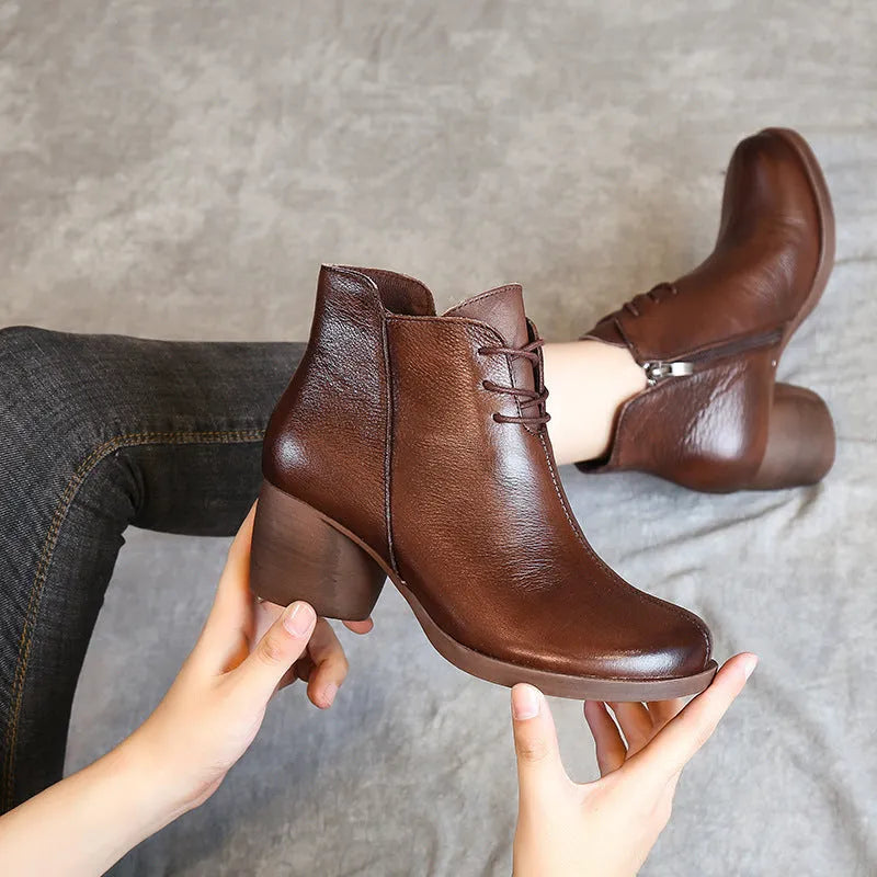 Brown leather women's Martin boots with a thick heel and round toe on a white background.