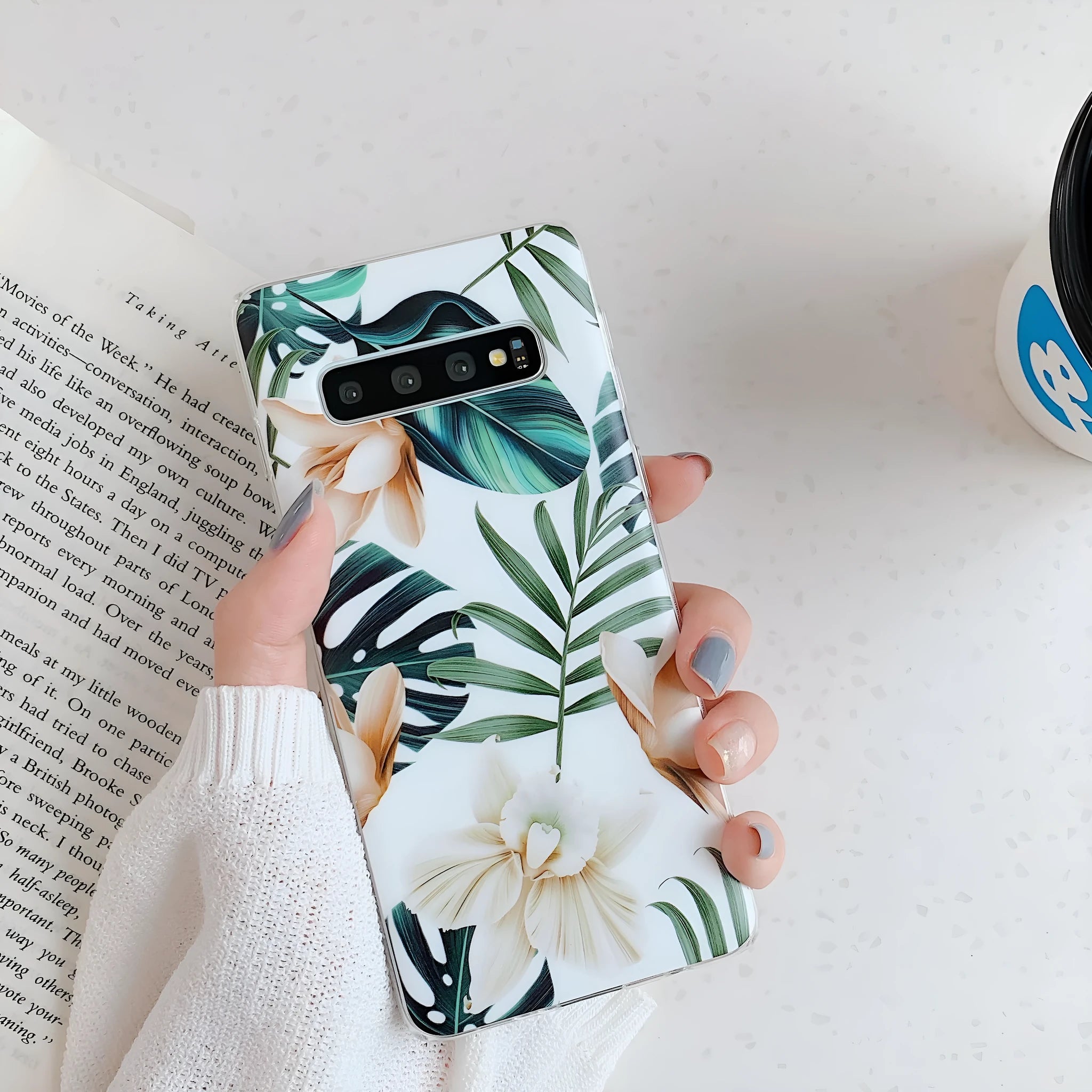 Green leaf flower patterned TPU phone case for Samsung Galaxy phones on a table.