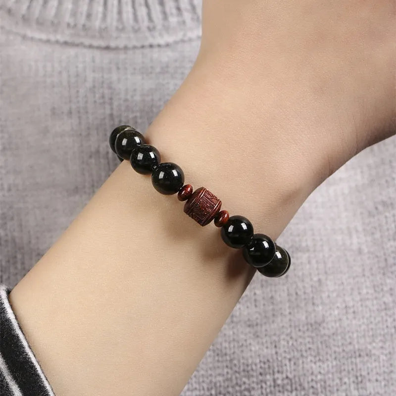 Hand-woven unisex bracelet with round 10mm golden obsidian beads in a vintage style.