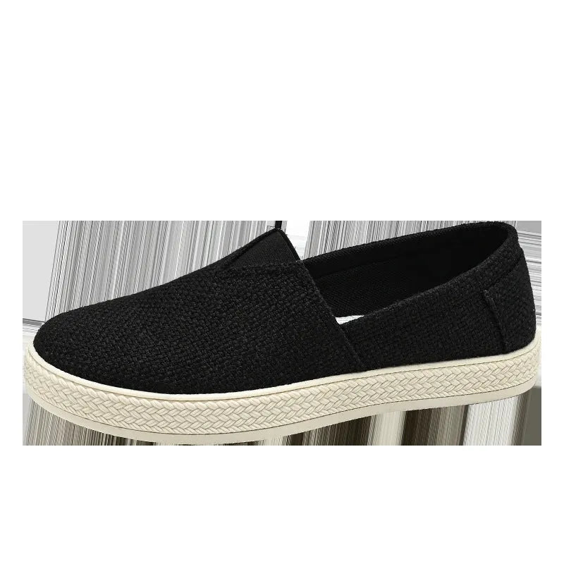 Men's beige linen canvas slip-on shoes with a round toe and shallow cut on a plain background.
