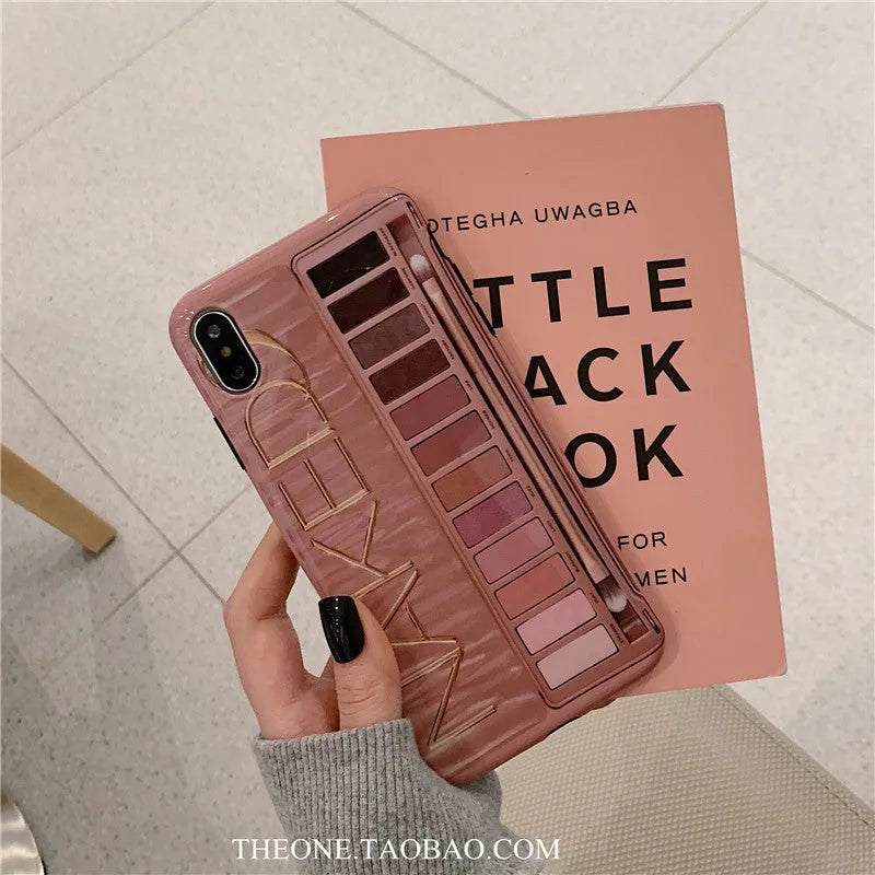 Flesh and grey silicone phone case for various iPhone models on a table.