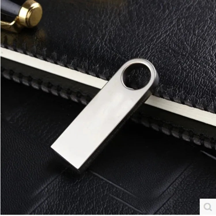 USB 2.0 flash drive with metal casing in gold and silver, compact size, and 128GB capacity for laptop use.