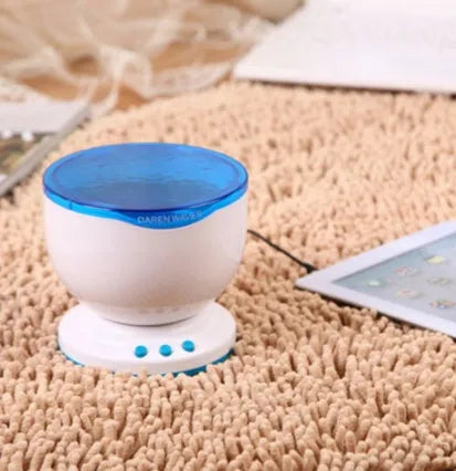 Blue ocean themed LED projection lamp for children's rooms on a shelf.