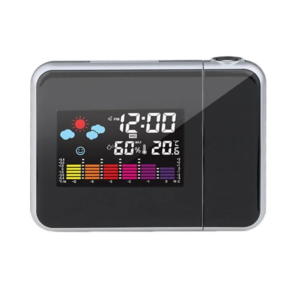 Black digital projection alarm clock on a surface, showing its compact plastic design.