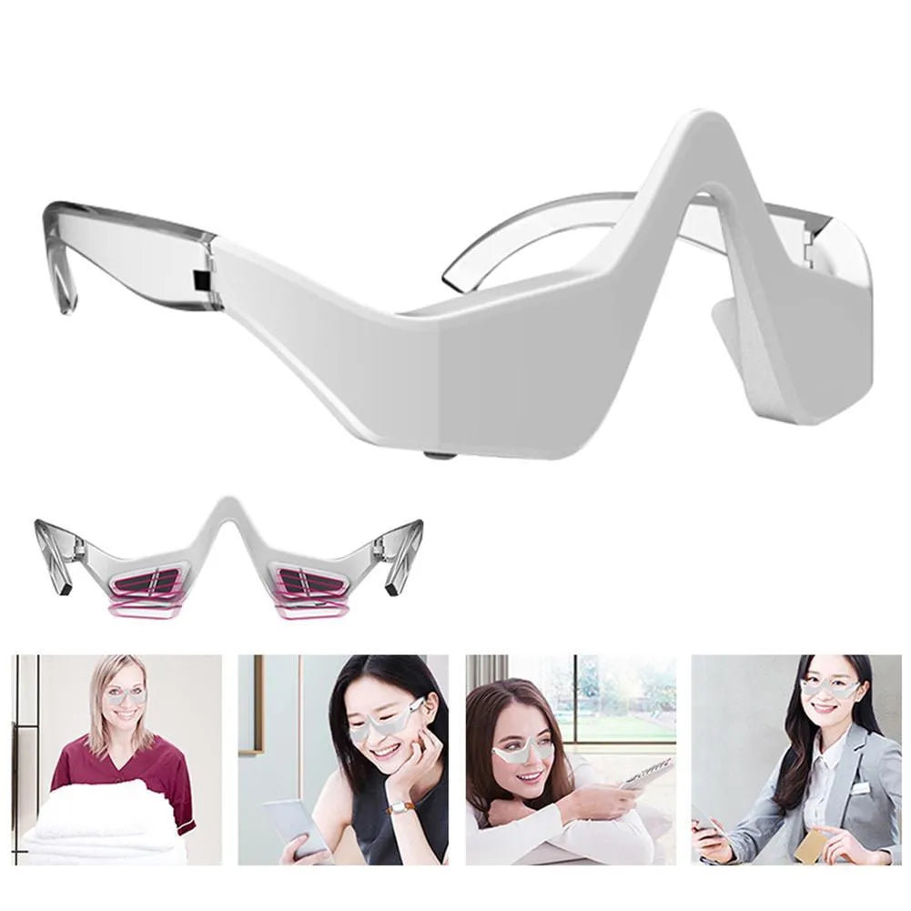 Pink and white micro-current eye massager with glasses-style frame on a grey background.