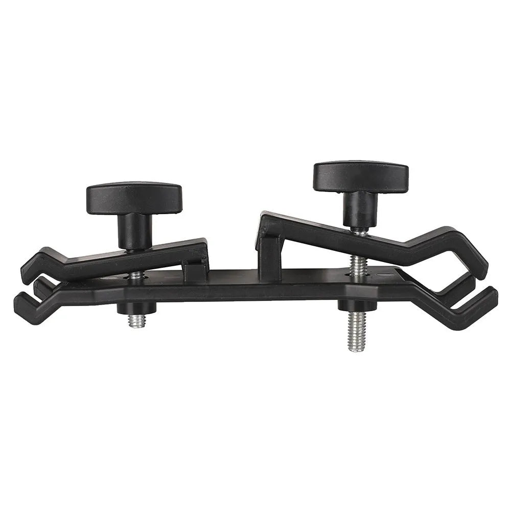 Black ABS plastic umbrella clip attached to a camera tripod shaft holding a compact umbrella.