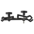 Black ABS plastic umbrella clip attached to a camera tripod shaft holding a compact umbrella.