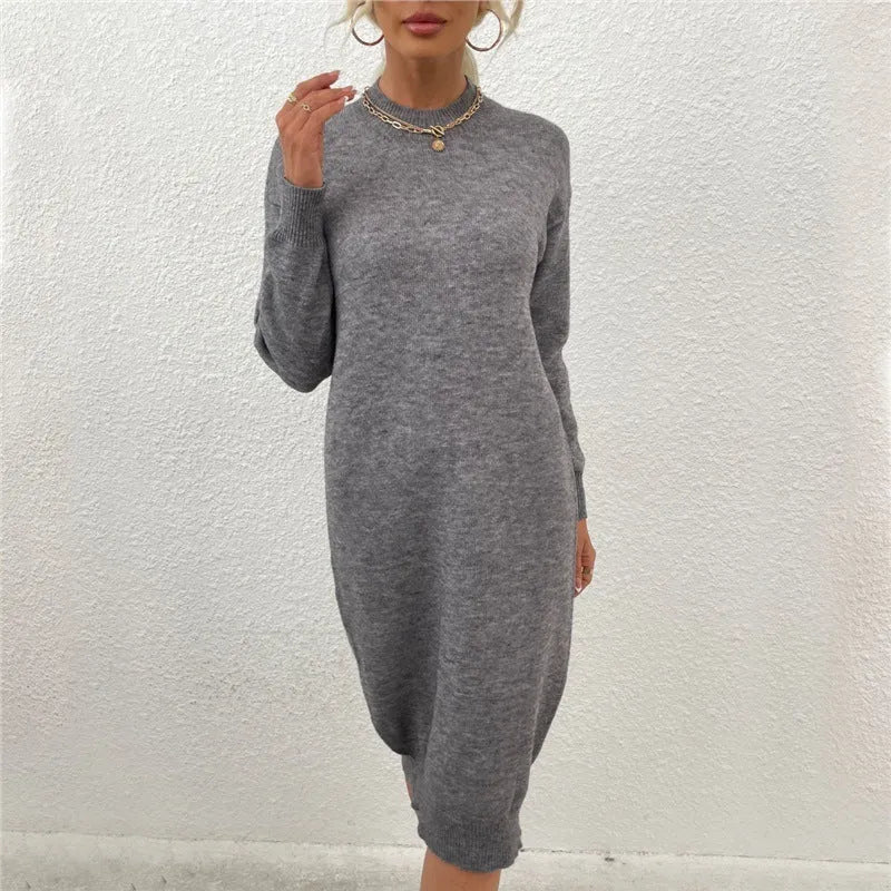 Grey women's crew neck long sleeve acrylic pullover sweater laid flat.