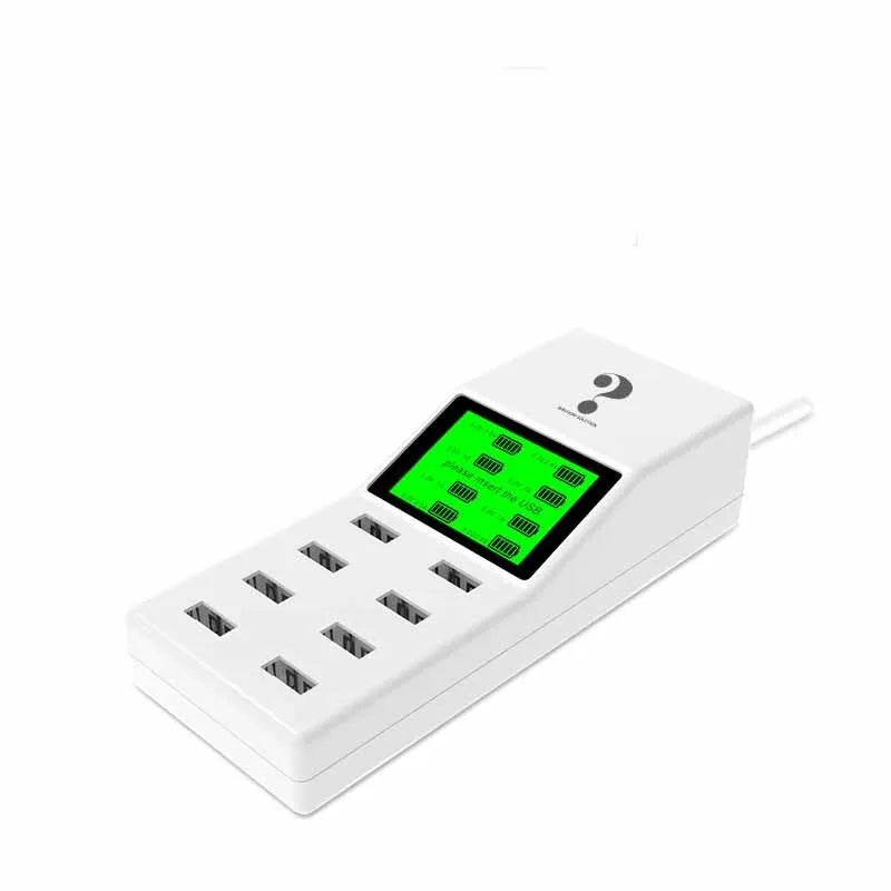White multi-port USB mobile phone charger with UK, EU, US plug adapters on a desk