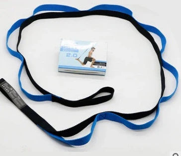 Adjustable yoga stretch belt with metal D-ring buckle on 4cm wide polyester webbing, folded beside training manual
