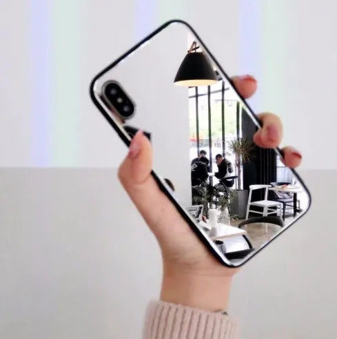 Black iPhone mirror phone case with reflective back cover for iPhone X and other models.