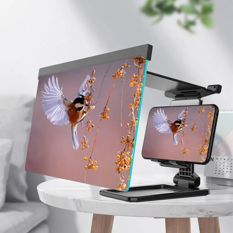 Black folding mobile phone screen magnifier and detachable holder on a desktop.