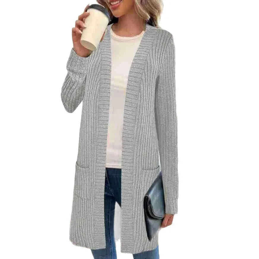 Black loose fit knitted cardigan jacket with long sleeves and side pockets on a mannequin.