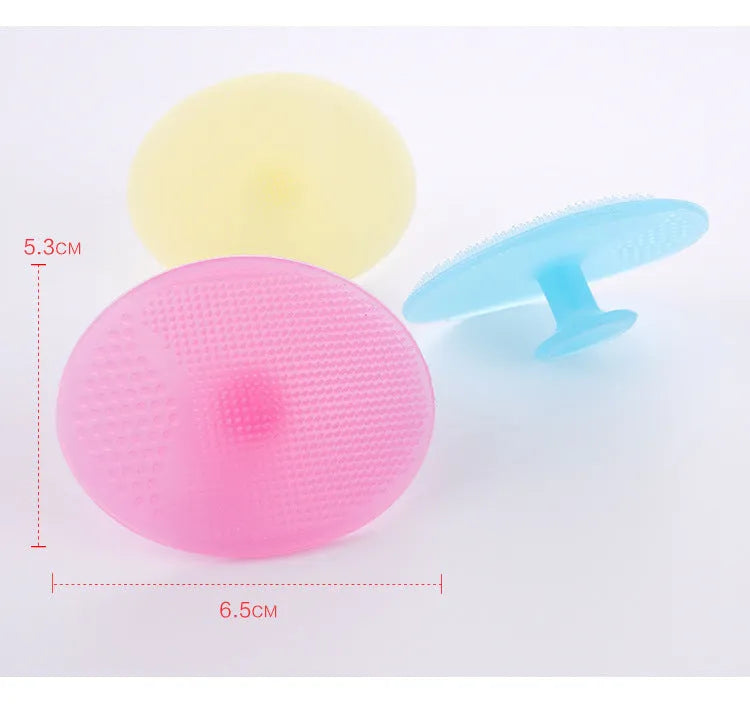 Silicone facial brush in three bristle zones with suction cup on blue background