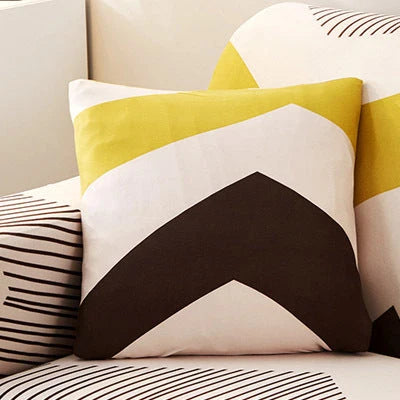 Printed stretchable sofa slipcover covering a three-seater sofa in a modern geometric pattern
