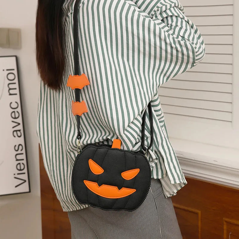 Horizontal view of a PU crossbody bag with pumpkin and bat cartoon design in orange colour option.