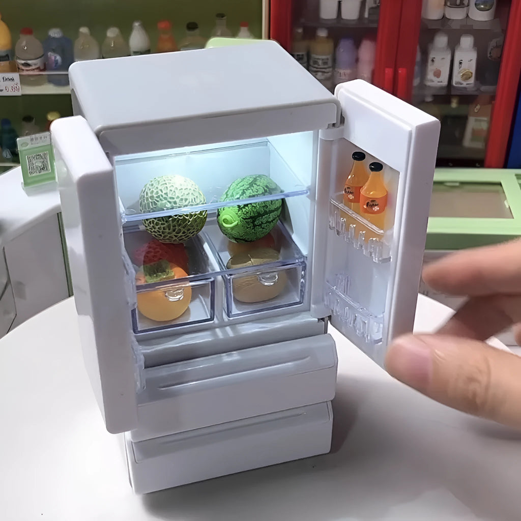 White plastic miniature candy toy model with illuminated light feature on a display surface.