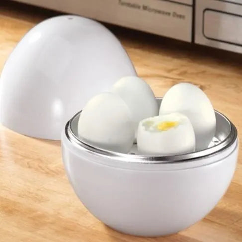 White microwave egg steamer cooker with lid, showing capacity for four eggs on a kitchen counter.
