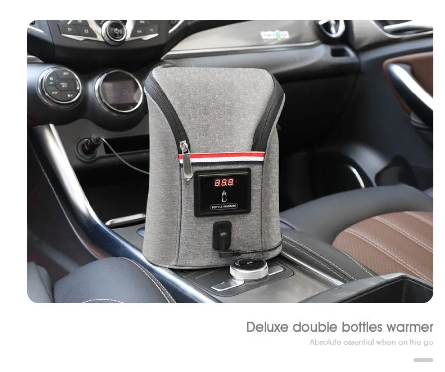 Grey Oxford cloth portable baby bottle warmer with electronic display and car charger, shown next to two baby bottles.