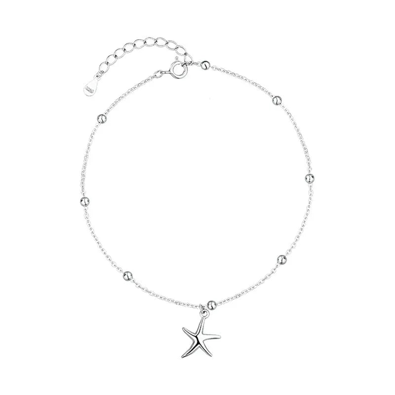 Sterling silver anklet with a starfish charm and round beads on a white background.