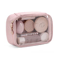 Clear PVC cosmetic bag with a zip open, showing a polyester lining and separate compartments.