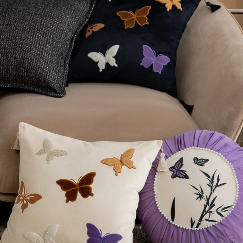 Square cushion with Chinese butterfly embroidery in beige, black, or purple colours.