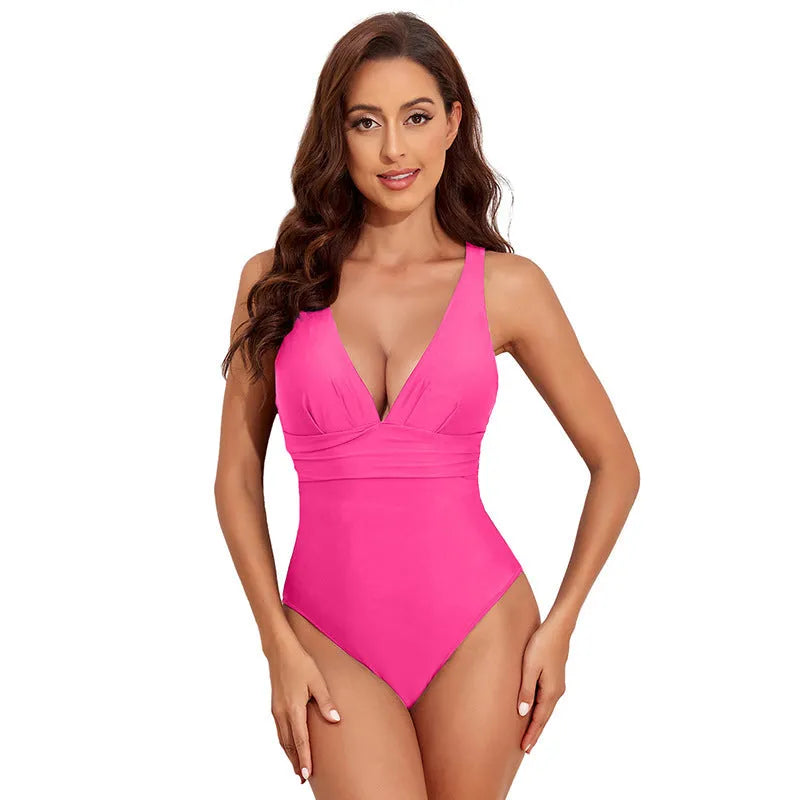 Women's solid colour cross shoulder one-piece swimsuit on a mannequin.