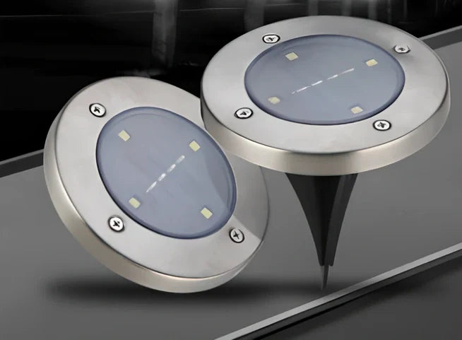 8LED waterproof solar garden light staked in lawn with warm glow, IP65 rated for rain resistance