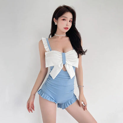 Women's one-piece swimsuit with adjustable bow detailing in solid colour