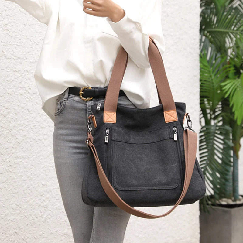 Women's canvas shoulder bag in multiple colours, showcasing spacious interior and zipper closure.