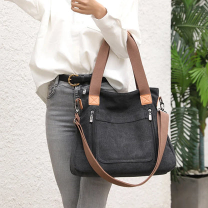 Women's canvas shoulder bag in multiple colours, showcasing spacious interior and zipper closure.