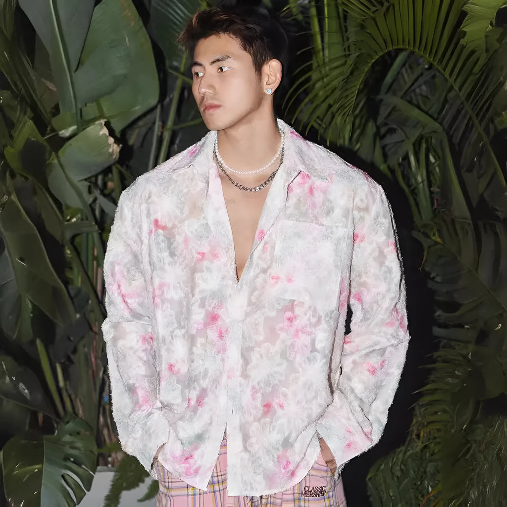 Pink loose fit floral long sleeve shirt with embossed three-dimensional pattern on a hanger.