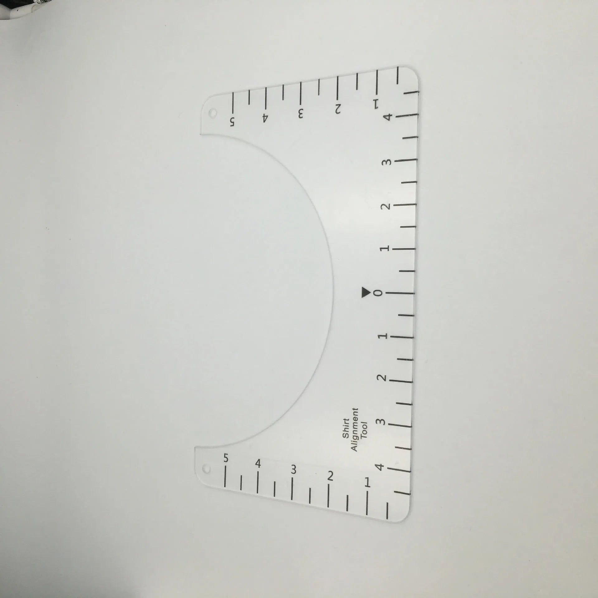 Transparent acrylic sewing ruler patch for T-shirt alignment, 10x6 inches.